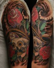 traditional skull and roses half sleeve tattoo by Kevin Riley at Studio One Tattoo Norwood PA Philadelphia